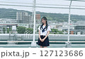 Smiling high school girl standing on the roof 127123686
