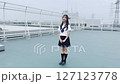 Smiling high school girl standing on the roof 127123778