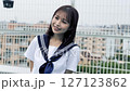 Smiling high school girl standing on the roof 127123862