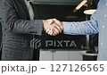 Business meeting handshake in corporate setting between professionals 127126565