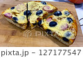 Pizza cooking process, homemade pizza slices with melted cheese and sausage. Pizza preparation in kitchen, close-up view. Concept make homemade pizza with simple delicious toppings. Slow motion video 127177547