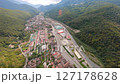 Flying over a mountain town road 127178628