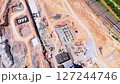 Aerial view of a cement plant construction site with visible foundations, machinery, and engineering structures 127244746