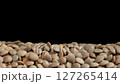 Close-up View of Organic Brown Lentils Piled Against Black Background in Studio 127265414