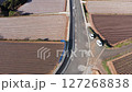 Drone flight over road and rice fields Japan 127268838