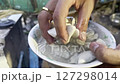 Asian cook is cooking in thai kitchen in local traditional country style, preparing fresh fish balls to cook thai food green curry popular worldwide 127298014