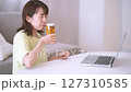 Young woman enjoying an online drinking party 127310585