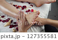 Unrecognizable male masseur's hand massages female feet during relaxation treatment 127355581