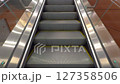 A close-up look at a clean moving escalator with metallic steps and surroundings in a contemporary indoor location. 127358506