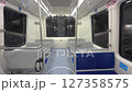 An empty driverless subway train showcases modern seating and spacious interior design in the late night hours, highlighting a quiet atmosphere. 127358575