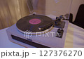 Close-up of vinyl record player needle on spinning turntable surface.  127376270