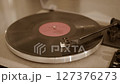 Close-up of vinyl record player needle on spinning turntable surface.  127376273