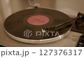 Close-up of vinyl record player needle on spinning turntable surface.  127376317