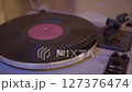 Close-up of vinyl record player needle on spinning turntable surface.  127376474