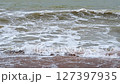 dirty water and big waves at sea during the monsoon season on a sandy beach. Slow motion 127397935