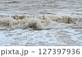dirty water and big waves at sea during monsoon season. Slow motion 127397936