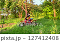 A motorcyclist rides off-road on a sports motorcycle. 127412408