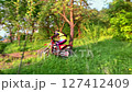 A motorcyclist rides off-road on a sports motorcycle. 127412409
