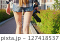 Faceless girl with professional camera walks. Back view 127418537