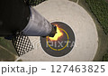The first stage of a private reusable rocket returns to Earth and lands on a landing pad. View from above 127463825