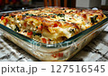 Delicious vegetable lasagna with cheese and spinach in glass baking dish 127516545