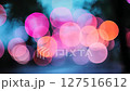 Cozy colorful pink blue bokeh lights in urban night scene, dark, haze 127516612
