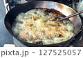 Boiling cooking oil in a large pan. Frying chicken in Thai street food style. 127525057
