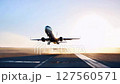 Cinematic Passenger Airplane Taking Off from Runway at Sunrise 127560571