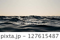 Ocean Waves with Sunlight and Bokeh Effect Relaxing Nature Background. Soft Sea Waves Sparkling in Sunset Light with Bokeh. 127615487