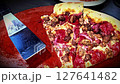 Delicious pizza featuring a combination of cheese and meat lovers toppings, served on a wooden board. The golden cheese stuffed crust and melting cheese emphasize fresh and irresistible flavors, creat 127641482
