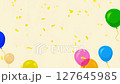 Golden confetti particles fall slowly and sparkle across the frame of colorful balloons 127645985