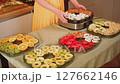 Housewife preparing a food dryer with sliced fruit and vegetables 127662146