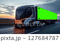 Futuristic autonomous electric truck on a future highway during the nighttime with informatiove leds lit up. 127684787