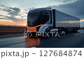 Futuristic autonomous electric truck on a future highway during the nighttime with informatiove leds lit up. 127684874