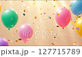 Golden confetti particles fall slowly and sparkle across the frame of colorful balloons 127715789