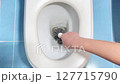 Vertical footage of black toilet brush in people hand. Cleaning toilet bowl concept. FullHD footage. 127715790