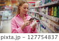 Customer scanning product with smartphone in supermarket 127754837