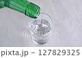Pouring chilled Korean soju (Japanese liquor), a traditional Korean distilled alcoholic beverage, into a glass - stock video 127829325
