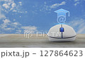 e-learning flat icon with wireless computer mouse on wooden table over blue sky with white clouds, Business study online concept 127864623