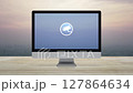 cctv camera flat icon on desktop modern computer monitor screen on wooden table over city tower and skyscraper at sunset, vintage style, Technology security and safety online concept 127864634