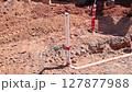Connected pvc wastewater pipe sections in trench, ensuring alignment installation under work day 127877988