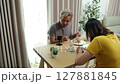 Middle-aged couple enjoying holiday dinner together at home. 127881845