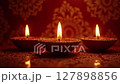 Glowing Diwali Diyas Rotating Mystically on Traditional Background 127898856