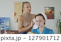 4K. The bride is getting ready for the wedding. A girl gets her hair done 127901712