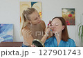 4K. The bride is getting ready for the wedding. The girl is being made up 127901743