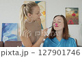 4K. The bride is getting ready for the wedding. The girl is being made up 127901746