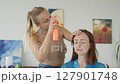 4K. The bride is getting ready for the wedding. A girl gets her hair done 127901748