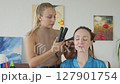 4K. The bride is getting ready for the wedding. A girl gets her hair done 127901754