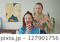 4K. The bride is getting ready for the wedding. A girl gets her hair done 127901756
