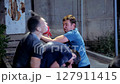 Street fight between three men using a fire extinguisher at night 4k slow motion 127911415
